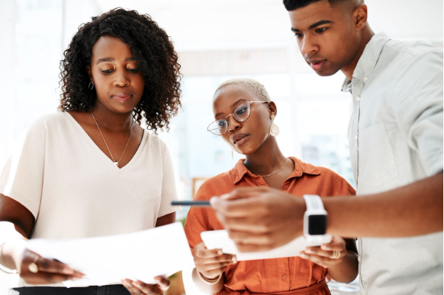 Nonprofit executive team reviewing operations strategy with a consultant” Nonprofit executive team reviewing operations strategy with a consultant”